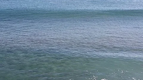 Clear water waves rolling by the beach Video stock 146734287