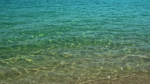 Clear waters gently lap against sandy shores. Trani Ammouda, Greece Stock Footage 339614040