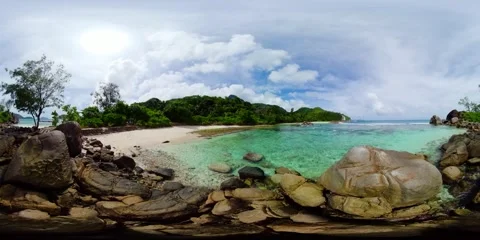 Clear waters lapping against rocky edges. Mahe, Seychelles. Stock Footage 301288255