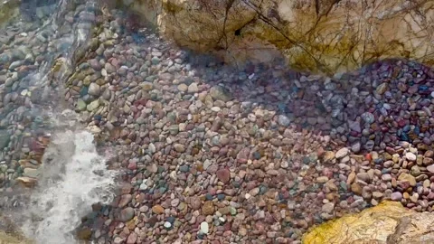 Clear wave between stones - stock video Stock Footage 240339640