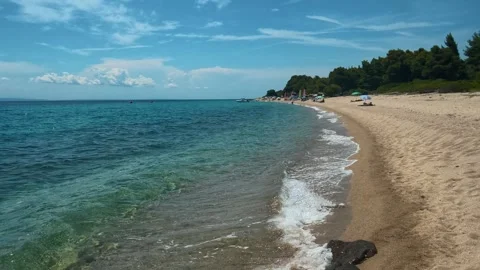 Clear waves roll onto soft sand. Lagomandra, Greece Stock-Footage 339023846