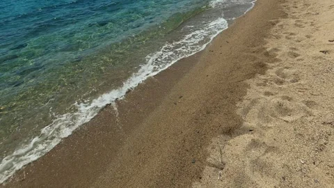 Clear waves wash soft sand at tranquil beach. Lagomandra, Greece Stock Footage 339023850