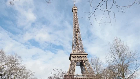 Clear white clouds speeding past Eiffel Tower on an early spring day Stock Footage 95263743