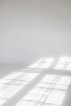 Clear white cyclorama. Light background with sun light and shadows. Plain wall Stock Photos