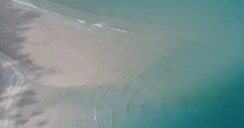 Clear white sand beach turquoise water with wave aerial look down view Stock Footage 96097614