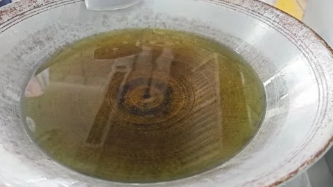 Clear yellow cooking oil in rustic iron wok. Stock Footage 342516322