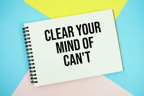 Clear Your Mind of Can't text written on notepad flat lay on multicolor pas.. Stock Photos