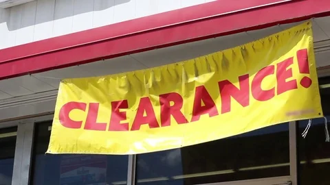 Clearance Banner hanging over the front entrance of a suburban store Stock Footage 78532754