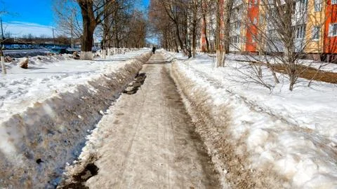 The cleared road in the park, cleaned in winter in city, the road cleaned by a Stock Photos