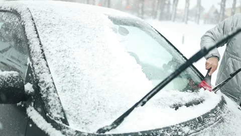 Clearing and remove snow from windshield, Scraping ice. Winter season car window Stock Footage 297702830