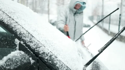 Clearing and remove snow from windshield, Scraping ice. Winter season car window Stock Footage 297703517