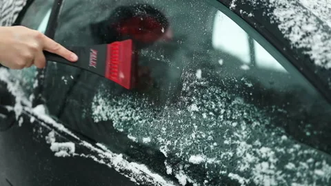 Clearing and remove snow from windshield, Scraping ice. Winter season car window Stock Footage 297706142