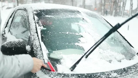 Clearing and remove snow from windshield, Scraping ice. Winter season car window Stock Footage 297707095