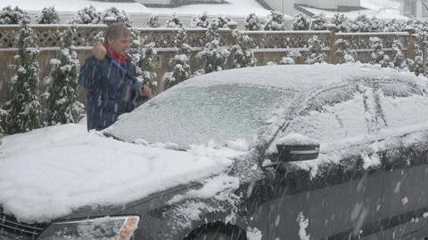 Clearing car of snow. Side view. Cinelike D. Ungraded. Video stock 103395154