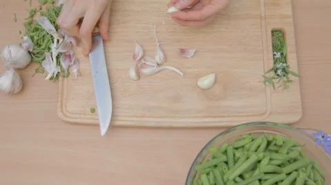 Clearing from dry husks every single clove of garlic outdoors Stock Footage 8367731