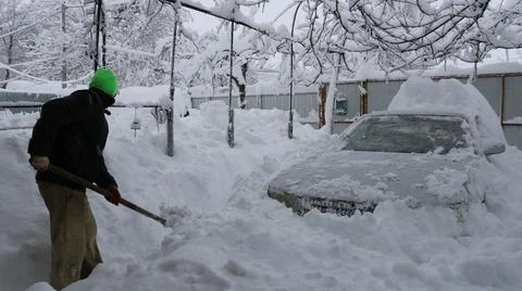 Clearing the path to the car after a heavy snowfall Stock Photos