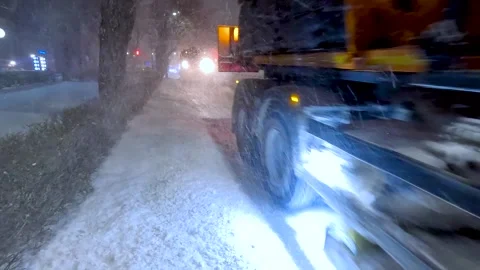 Clearing roads during a winter snowstorm Stock Footage 320996360