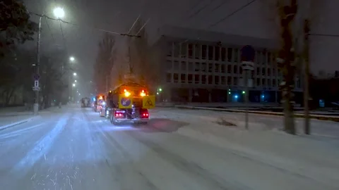 Clearing roads during a winter snowstorm Stock Footage 320997352