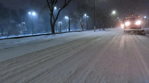 Clearing roads during a winter snowstorm Stock Footage 321612088