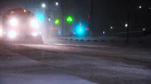 Clearing roads during a winter snowstorm Stock Footage 324855234