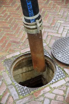 Clearing a sewage drain system Stock Photos
