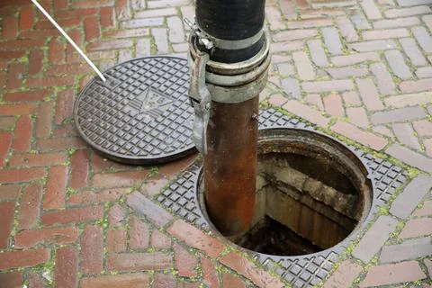 Clearing a sewage drain system Stock Photos