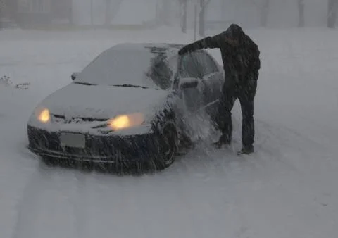 Clearing Snow off the Car. Stock Photos