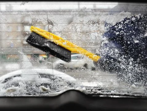 Clearing snow from car window Stock Photos