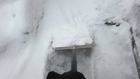 Clearing snow with shovel from yard Video stock 146883879