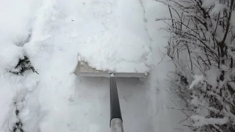 Clearing snow with shovel from yard Stock Footage 146883909