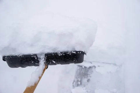 Clearing snow from the sidewalk Stock Photos