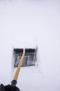 Clearing snow from the sidewalk Stock Photos