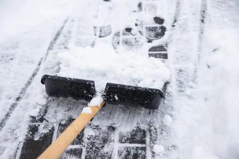 Clearing snow from the sidewalk Stock Photos