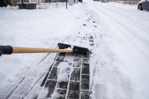Clearing snow from the sidewalk Foto stock