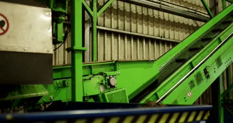 Cleated Conveyor Feeding Blue Hopper, Recycling Plant, Static Shot Stock Footage 340674163