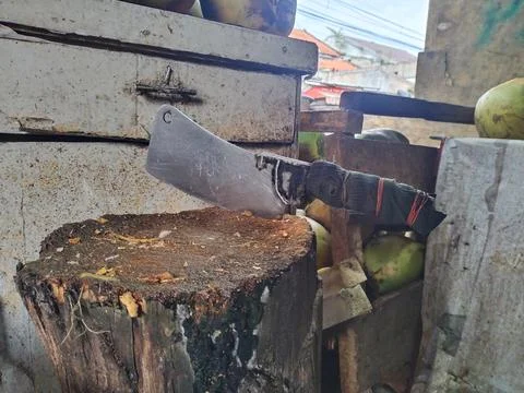 A cleaver stuck in a tree trunk Stock Photos