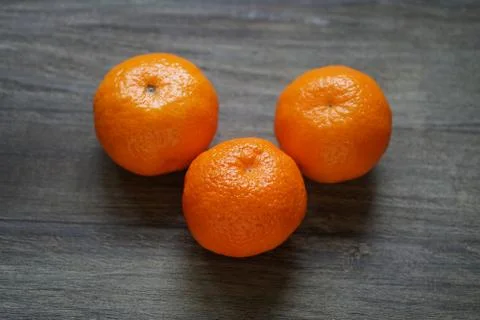 Clementines or mandarin oranges on rustic wooden table Stock Photos
