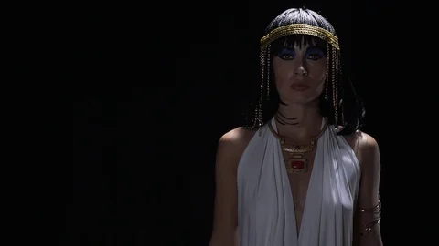 Cleopatra in dramatic lighting is doing an egyptian dance with her hands Stock Footage 112862236