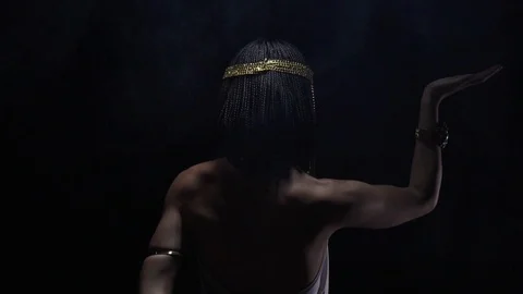 Cleopatra in dramatic lighting reaching her back with a hand, slow motion Video stock 112863713