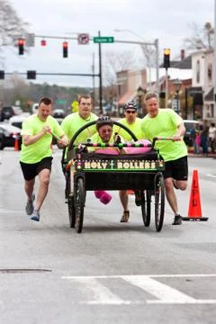 Clergymen push holy rollers bed in annual fundraiser race Stock Photos
