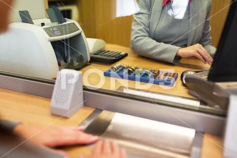 Clerk counting cash money at bank office Stock-Fotos
