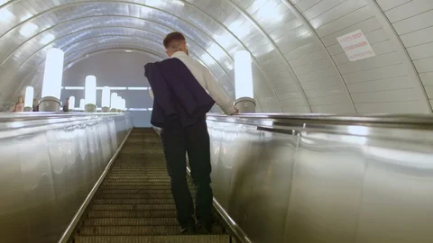 Clerk going up on escalator Stock Footage 120663713