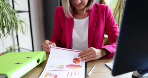 Clerk prepares approval of document using stamp on sales report before sending Stock Footage 220085567