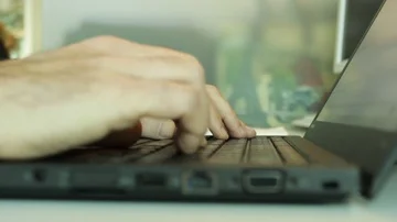 Clerk programmer man working at his cubicle on laptop without mouse use trackpad Stock Footage 85760928