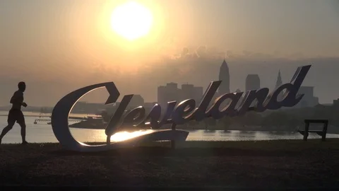 Cleveland, Ohio Sign at Sunrise, man running Stock Footage