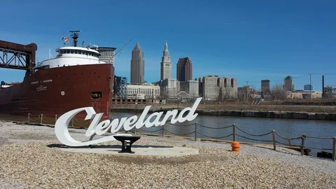 Cleveland Script Sign from the Flats as a cargo boat passes Stock Footage 129274560