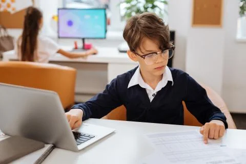 Clever boy correcting mistakes in a document Stockfoto's