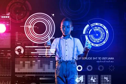 Clever boy using the diagrams while studying in a coding school Foto stock