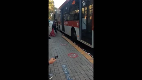 Clever can crusher uses buses to flatten trash in Santiago, Chile Stock Footage 276893572