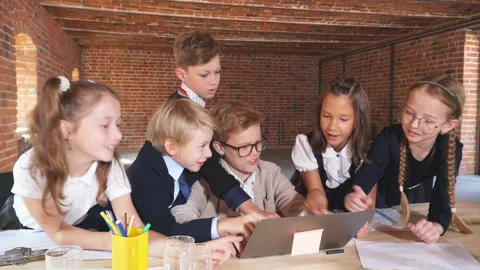 Clever children cracking the code, little bloggers sitting at the laptop Stock Footage 117051036